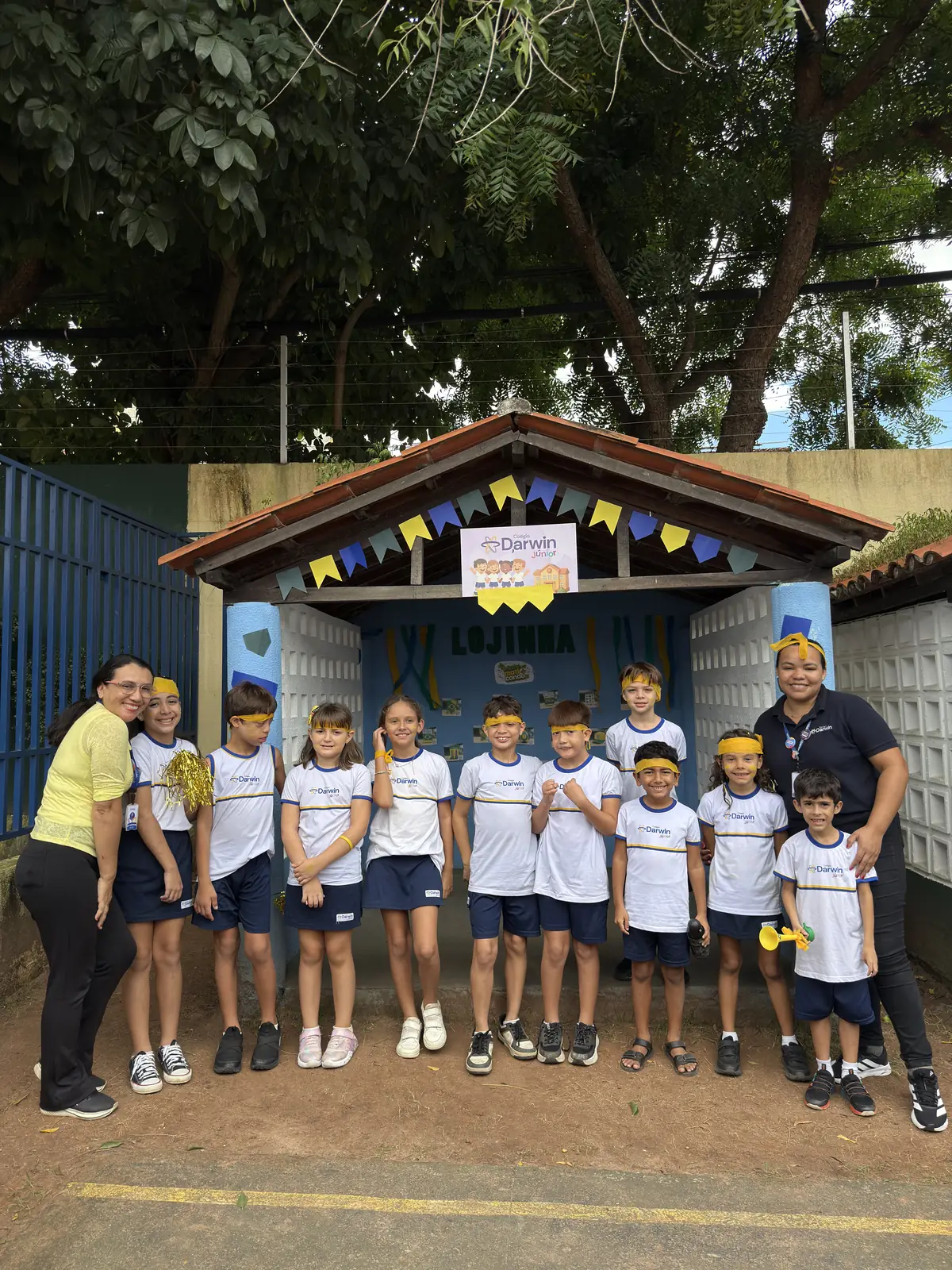 Alunos posando em frente à Lojinha do projeto pedagógico.