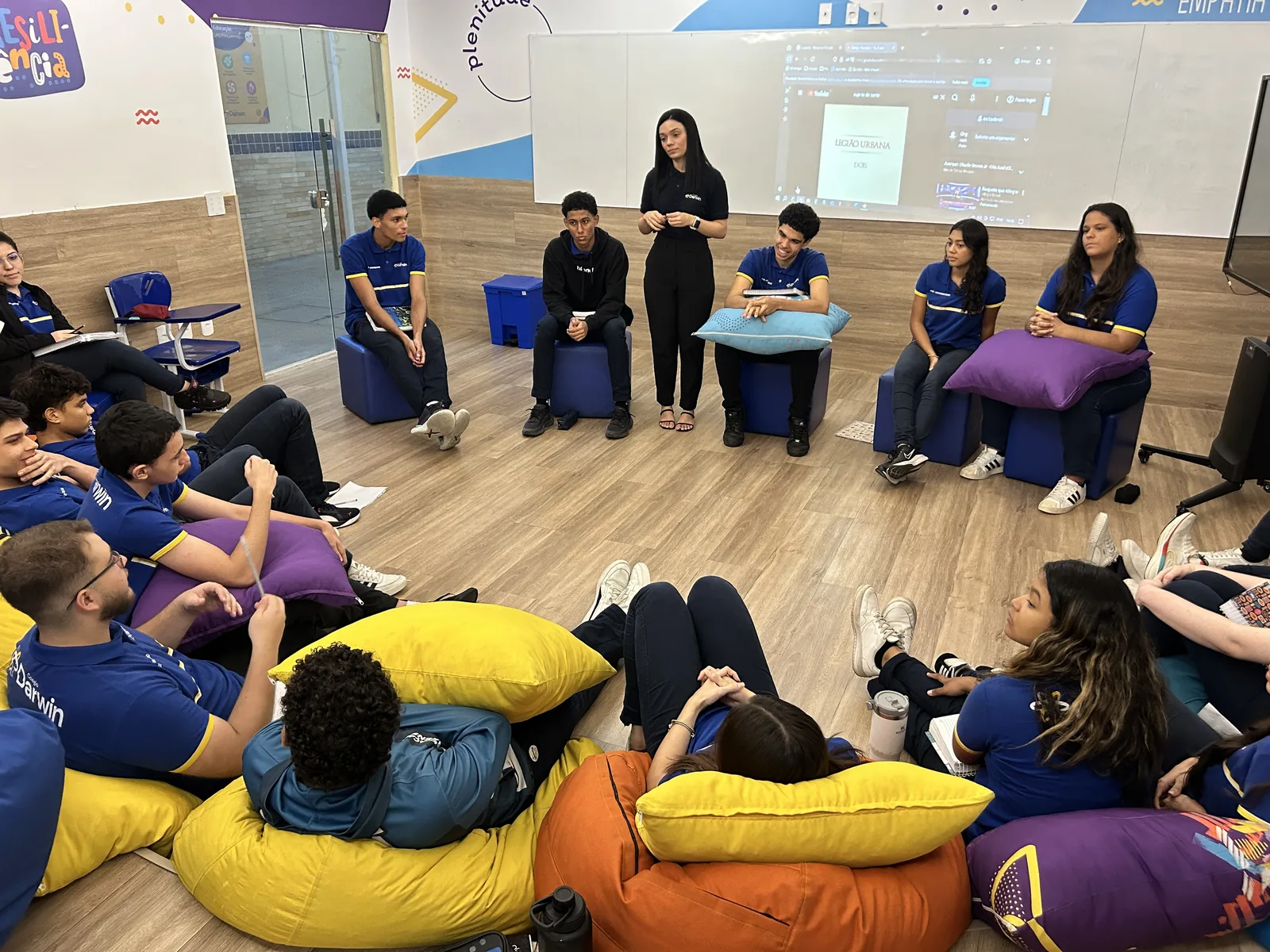 Turma do Ensino Médio do Darwin em aula de Projeto de Vida, em roda sobre almofadas coloridas.