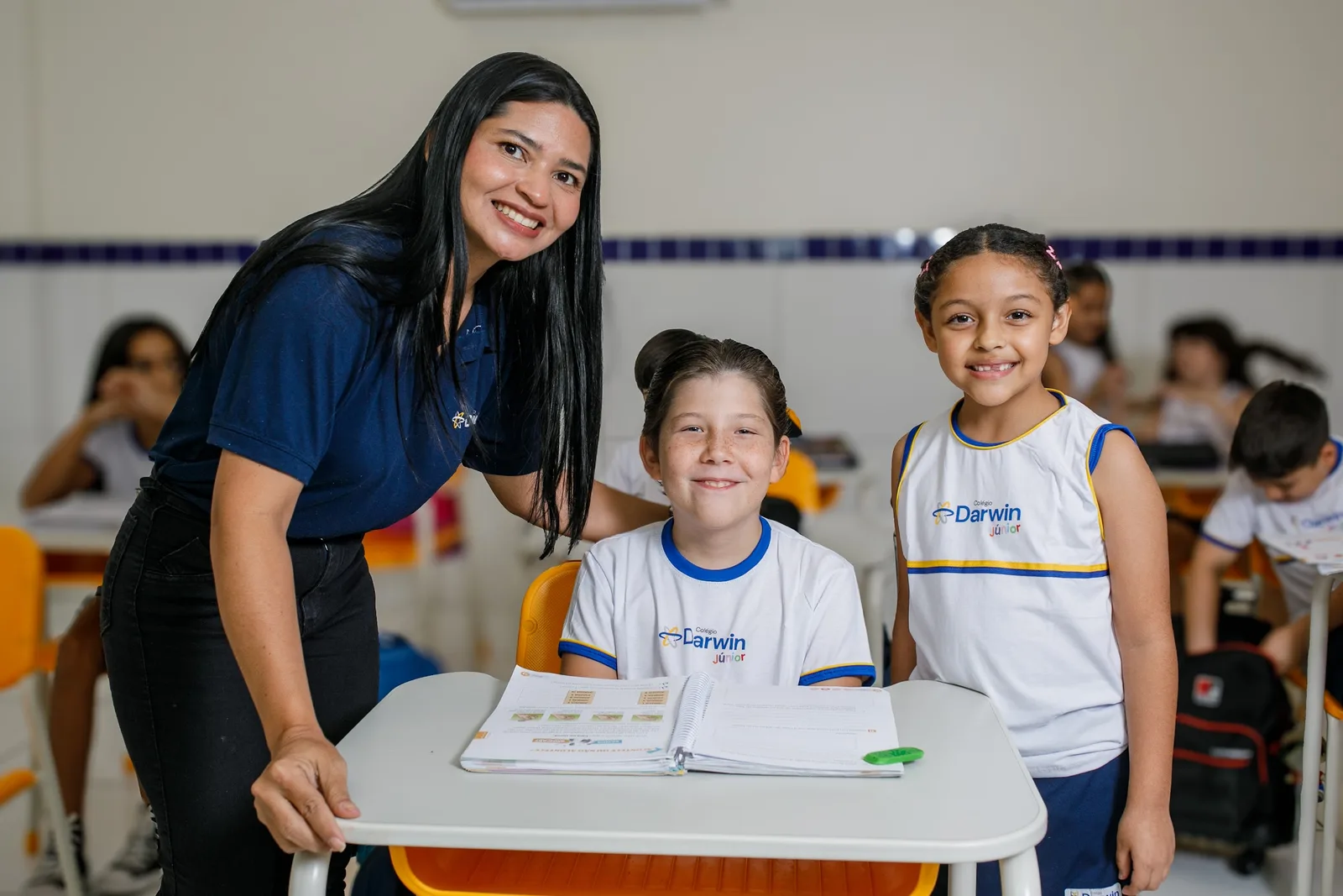 Professora acompanhando duas alunas dos Anos Iniciais em sala de aula na Sede Dionísio Torres